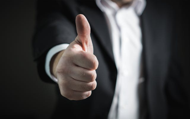 person-in-suit-thumbs-up